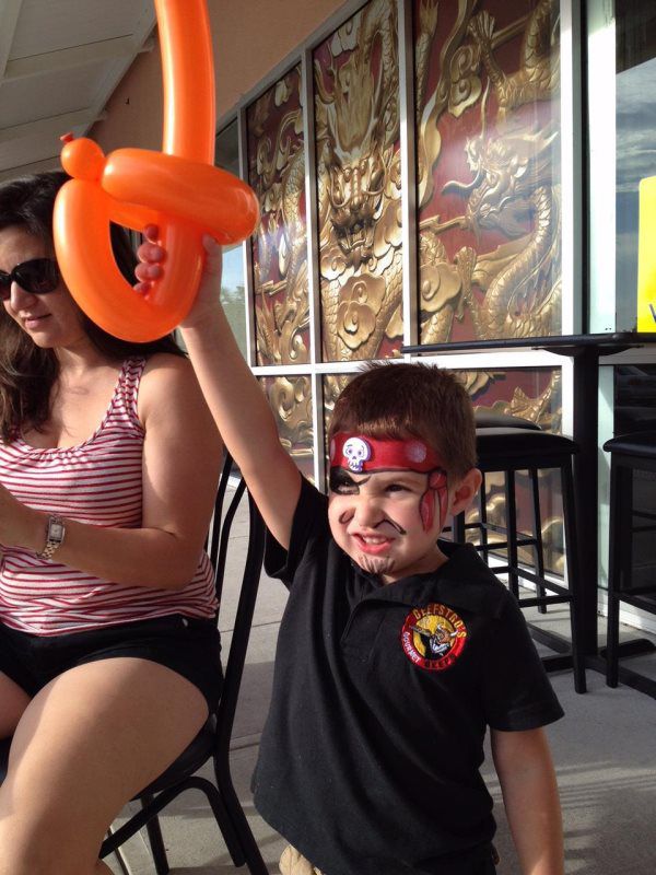 kid with orange balloon