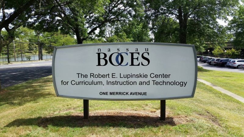 Mineola Monument Pylon Signs
A modern metal panel monument sign with brushed aluminum panels and bold, backlit lettering, installed at the entrance of a high-end corporate office complex.
The sleek metal panel monument sign is a modern and durable si