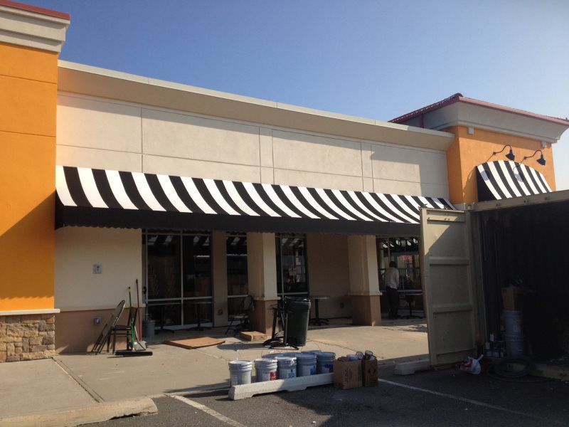 Mineola Awnings Signs
Shop front awning by Mineola Signs and Awnings in Mineola, New York
A vibrant shop front awning by Mineola Signs and Awnings, strategically located in Mineola, New York. This awning not only provides shade but also attracts cust