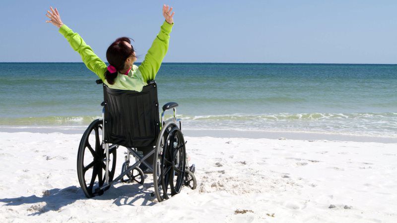 girl on the wheelchair in the beach